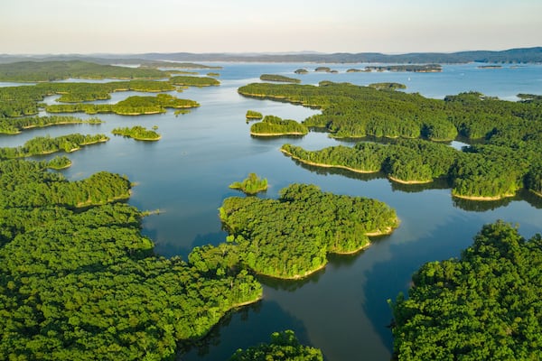 An aerial view of a network of islands surrounded by water, with dense green forests covering the land.
