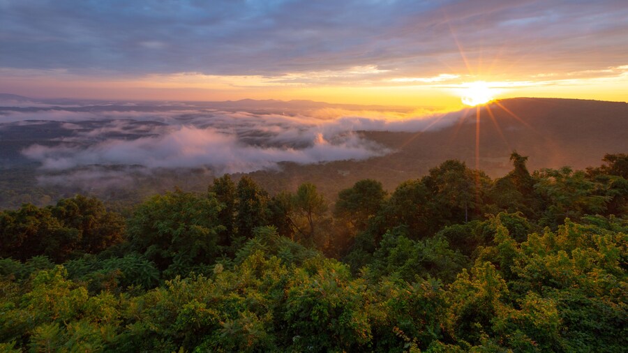 Morning sun rays through clouds and fog over mountains at Arkansas Grand Canyon Scenic Overlook