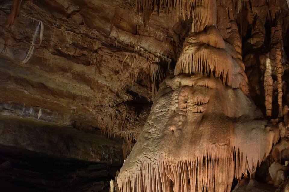 A cave with prominent stalactites and stalagmites.