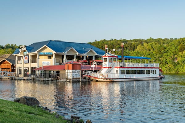 A waterfront building with a dock and a boat named 'Lake Queen'.