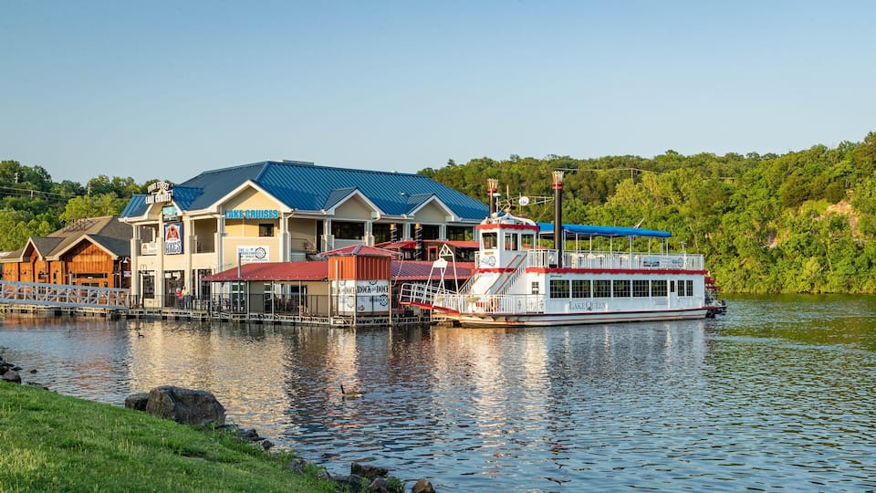 A waterfront building with a dock and a boat named 'Lake Queen'.