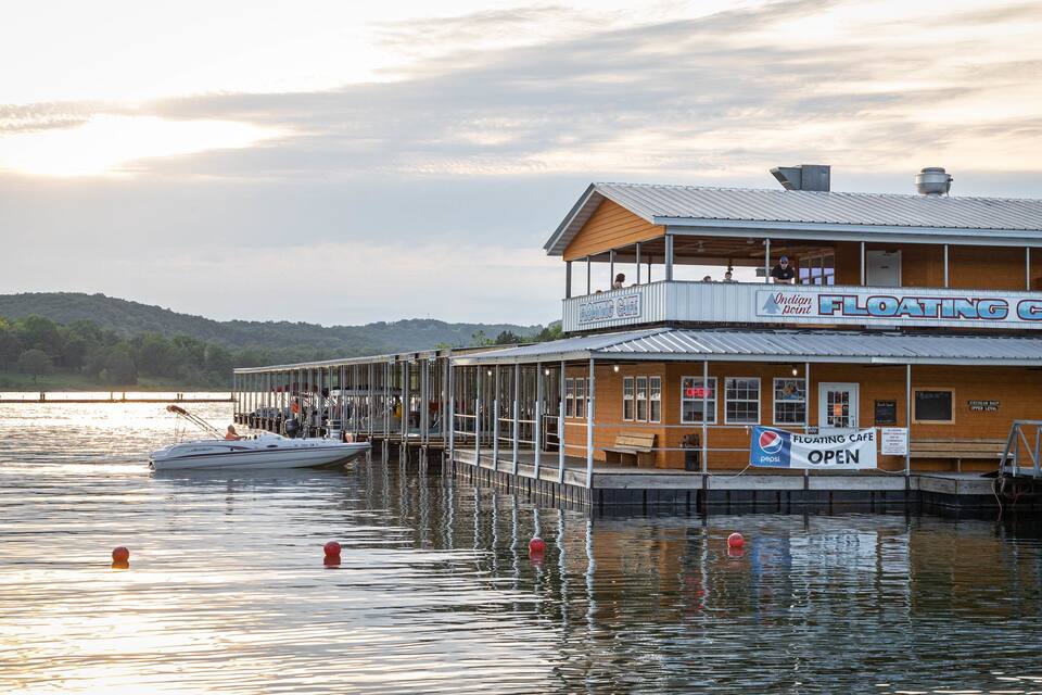 A floating cafe with a sign that reads "Floating Cafe" and "Open".