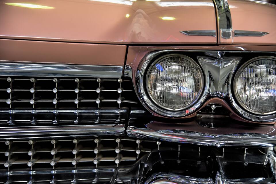 A close-up of a classic car's front grille and headlights.