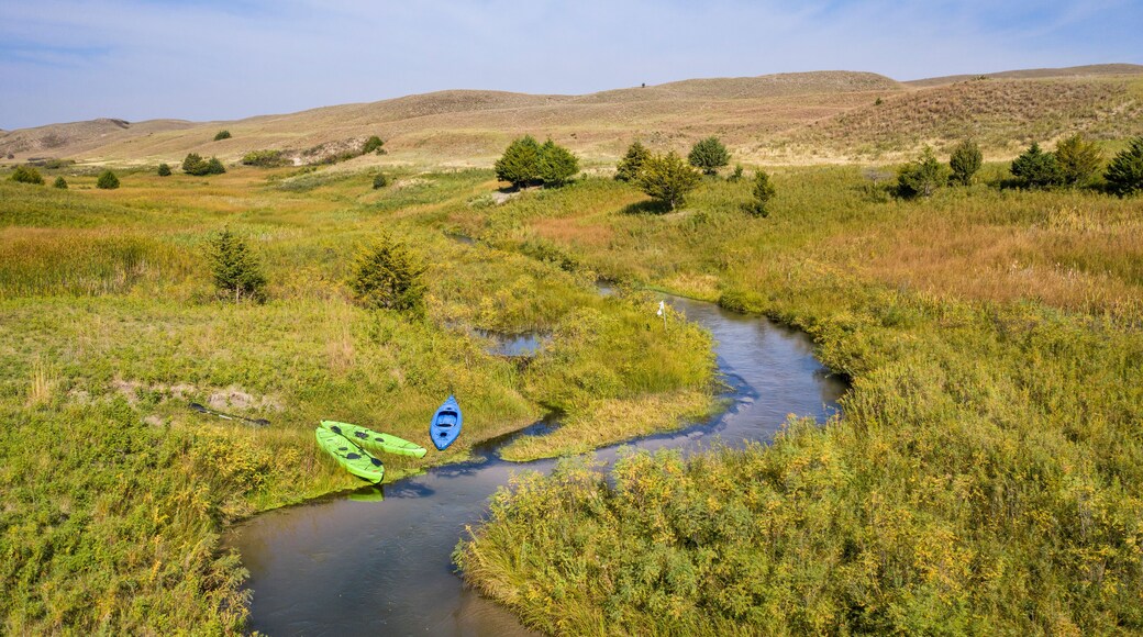 kayaks on the shore of a stream meandering in Nebraska Sandhills - North Fork of Dismal River near Dismal River Golf Club, early fall aerial view