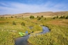 kayaks on the shore of a stream meandering in Nebraska Sandhills - North Fork of Dismal River near Dismal River Golf Club, early fall aerial view