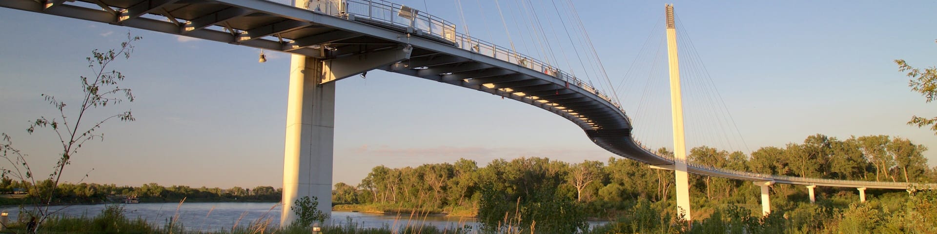 Bob Kerrey Pedestrian Bridge showing a bridge, a sunset and a river or creek