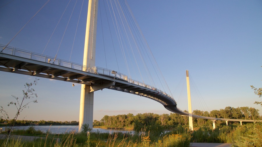 Bob Kerrey Pedestrian Bridge showing a bridge, a sunset and a river or creek