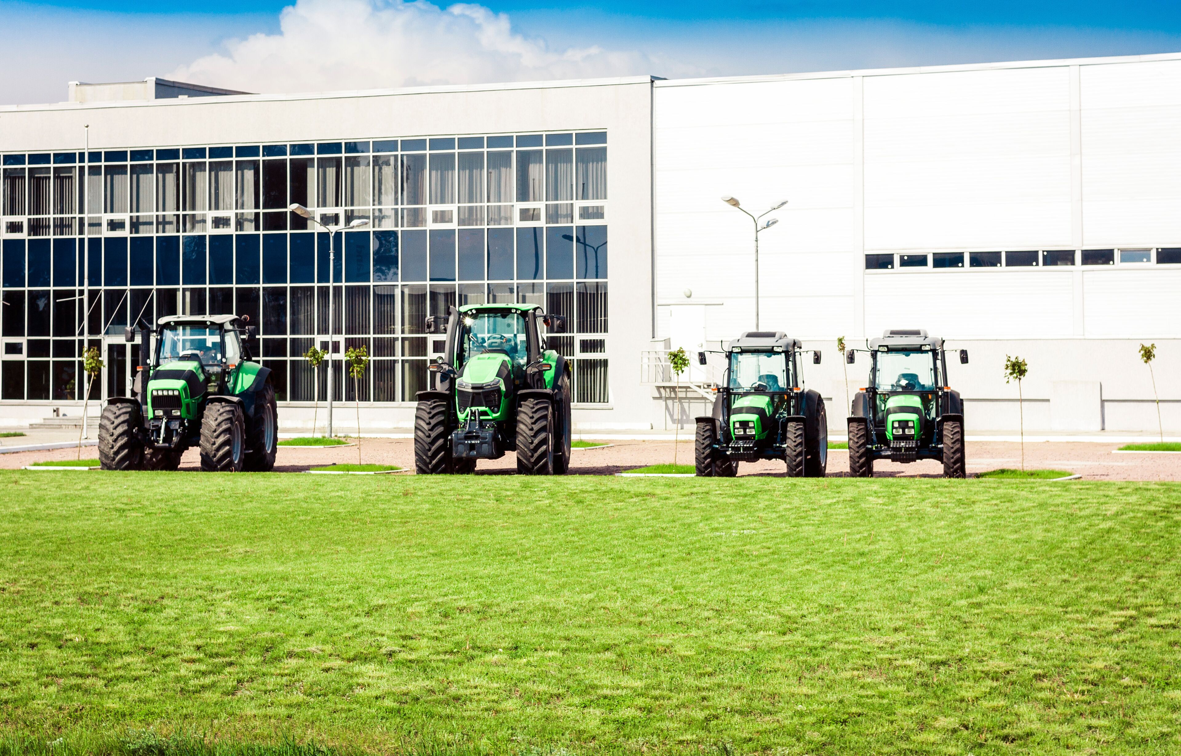 new tractors are standing next to the trading pavilion for sale in Kiev region, Ukraine.