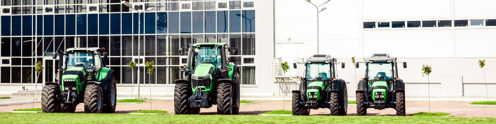 new tractors are standing next to the trading pavilion for sale in Kiev region, Ukraine.