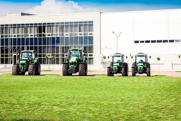 new tractors are standing next to the trading pavilion for sale in Kiev region, Ukraine.