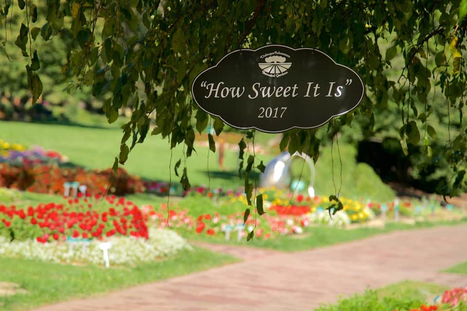 A garden sign reading "How Sweet It Is" with a date of 2017.