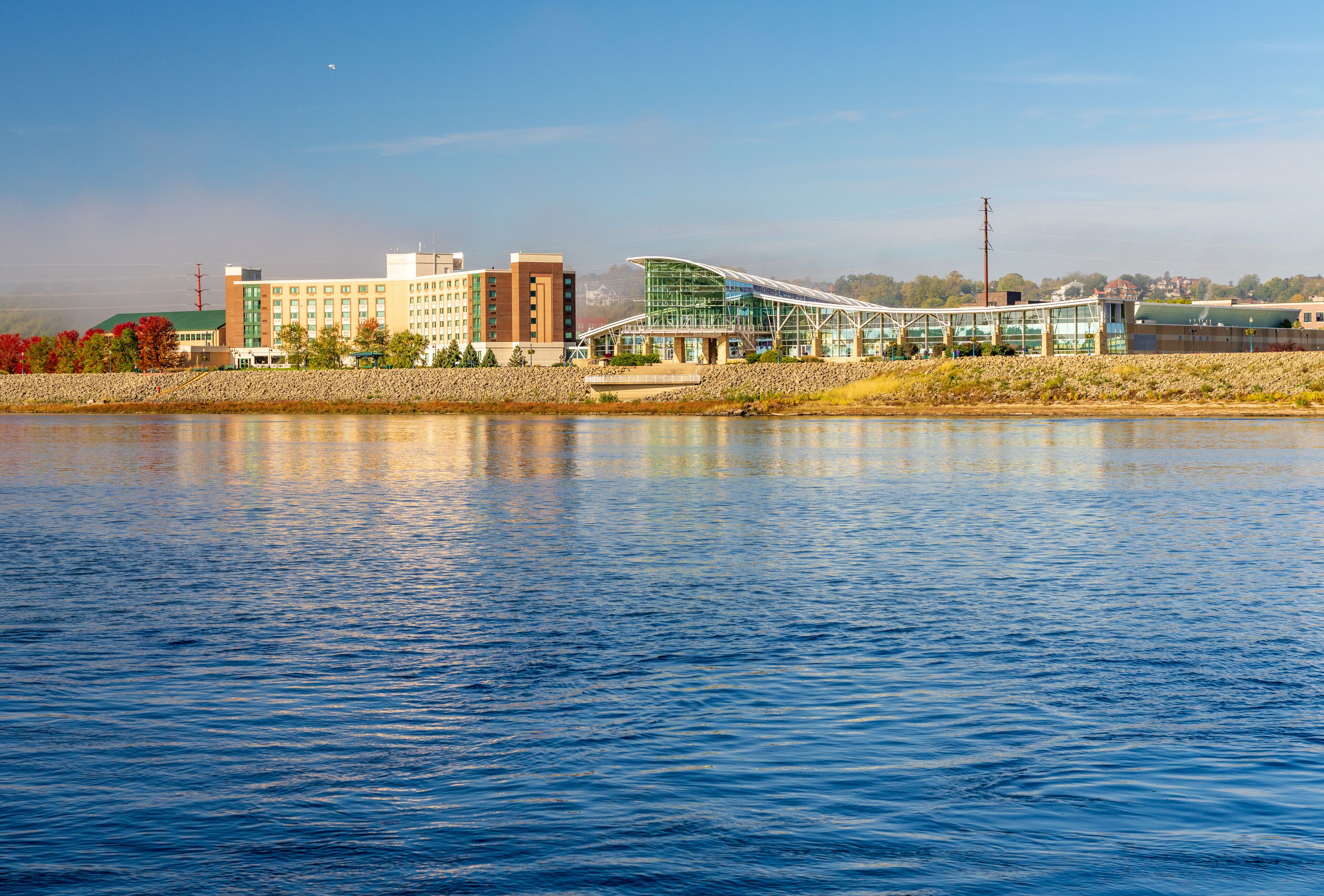 Casino hotel and convention center by Upper Mississippi on calm misty morning at Dubuque Iowa