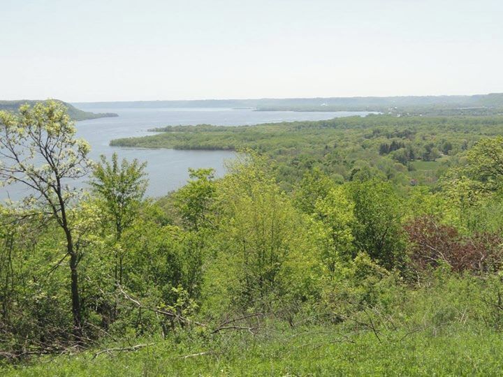 A lake surrounded by dense forest and hills.