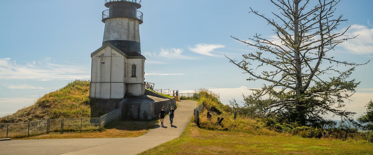 Cape Disappointment Lighthouse featuring a lighthouse as well as a couple