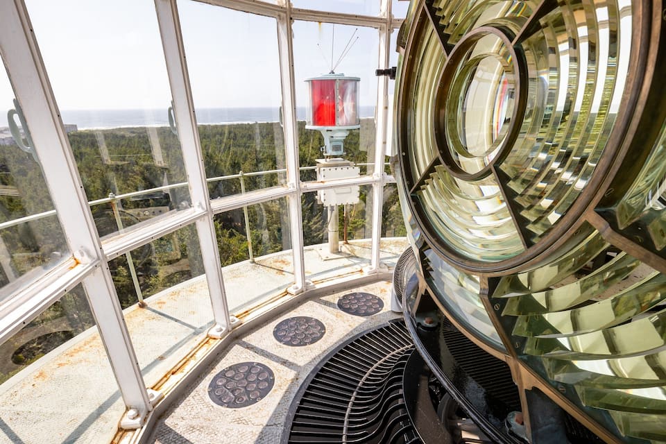A glass-enclosed observation tower with a red lantern and a circular viewing platform.