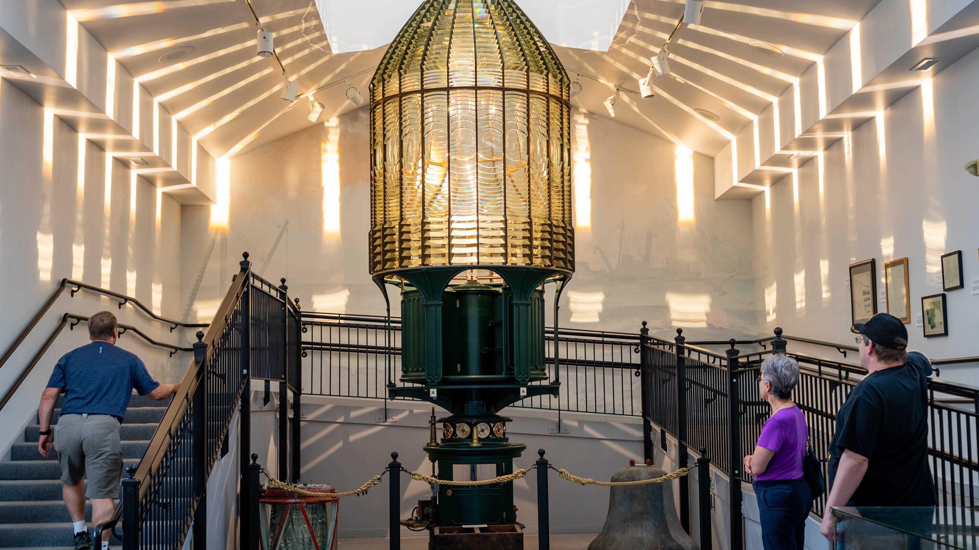 Westport Maritime Museum featuring a lighthouse and interior views as well as a small group of people