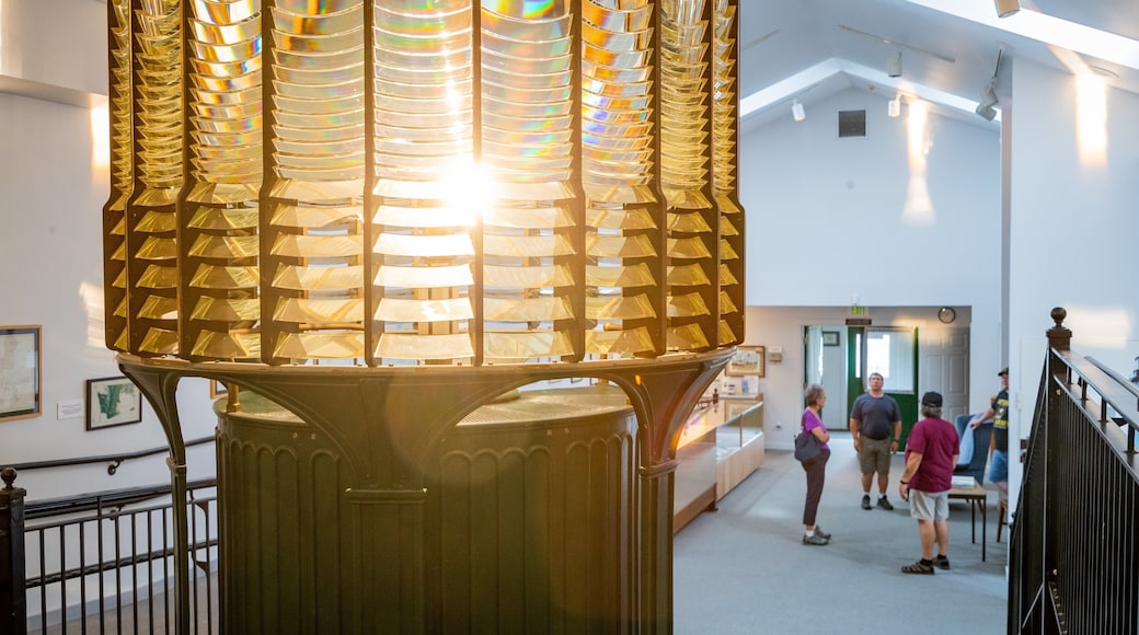 Westport Maritime Museum which includes a lighthouse and interior views as well as a small group of people