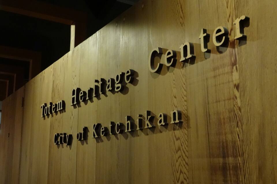 A wooden sign with the text "Totem Heritage Center City of Kechikan".