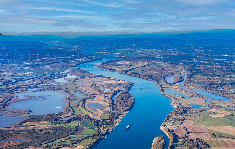 Aerial view of Sauvie island farm and wildlife area and the Columbia River leading west toward Astoria, Oregon, from Vancouver, Washington