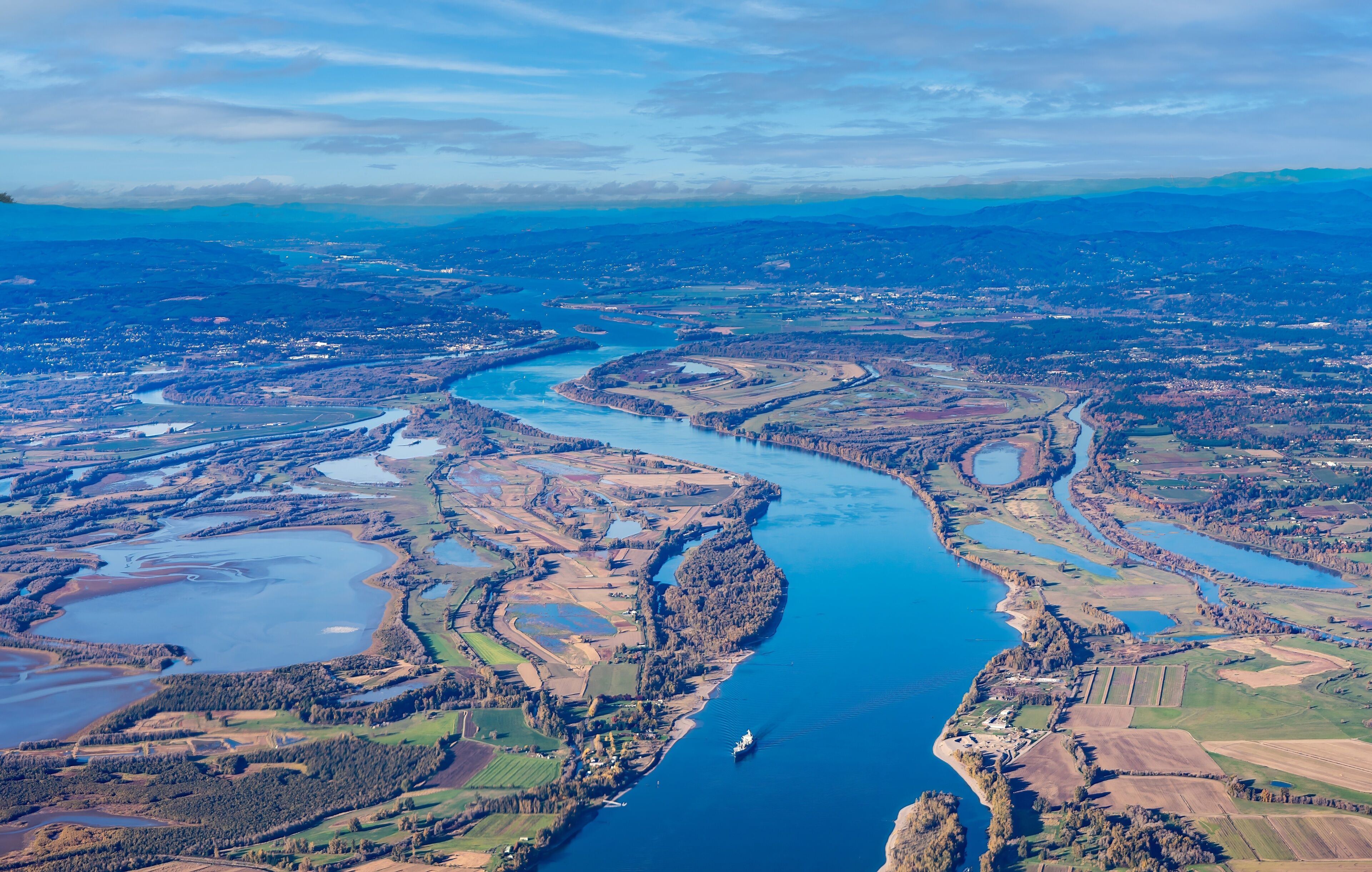 A river winding through a landscape with fields and small towns.