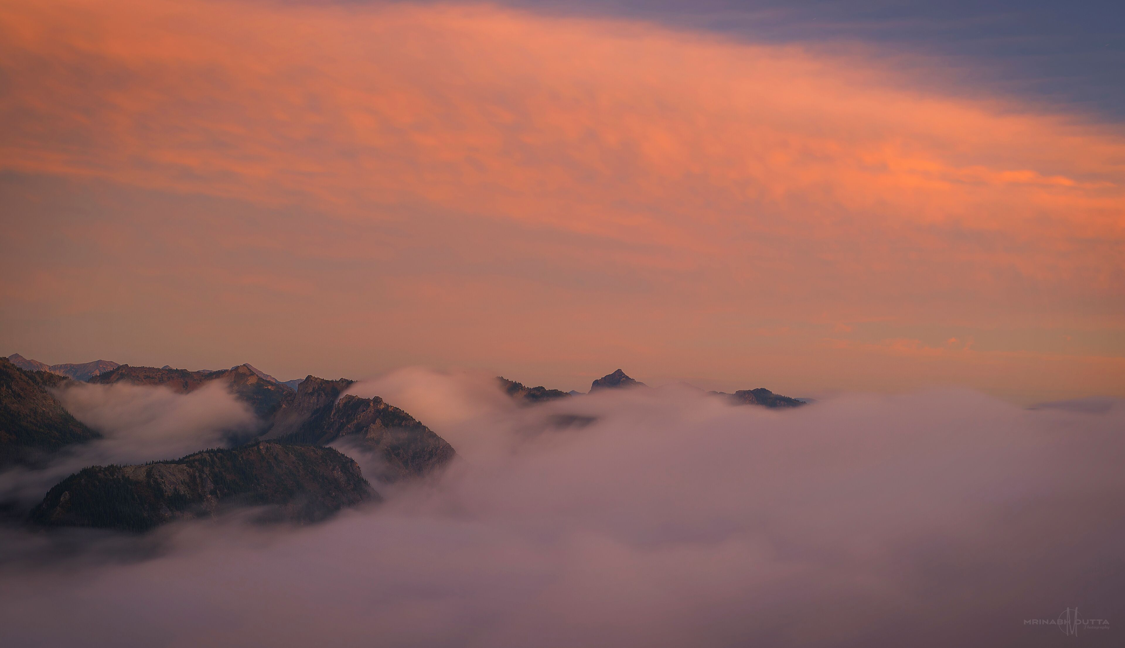 #Golden sunset over fog soaked ridge mountains.