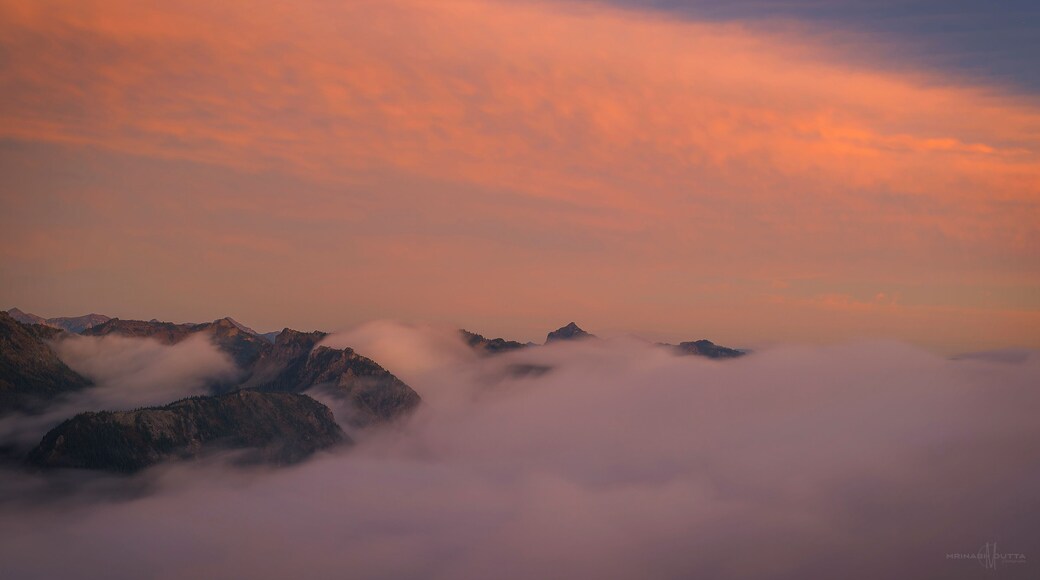 #Golden sunset over fog soaked ridge mountains.