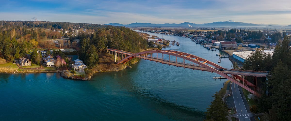 Rainbow Bridge and the City of La Conner, Washington. La Conner is a popular tourist town known for its arts and craft shops located in the beautiful Skagit Valley. Rainbow Bridge is an icon landmark.