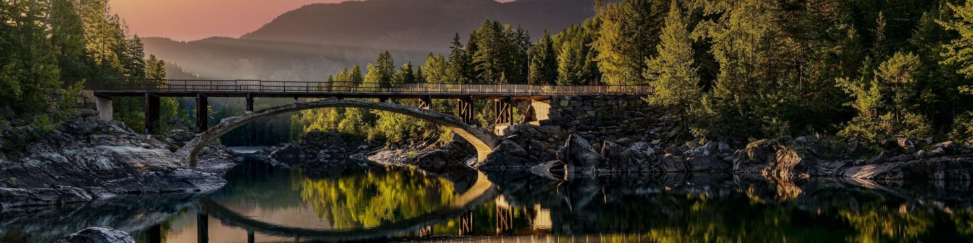 A sunrise across Belton Bridge over Middle Fork Flathead River near West Glacier in Glacier National Park, Montana, USA