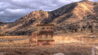 A sign for Lewis & Clark Caverns State Park with a mountainous backdrop.