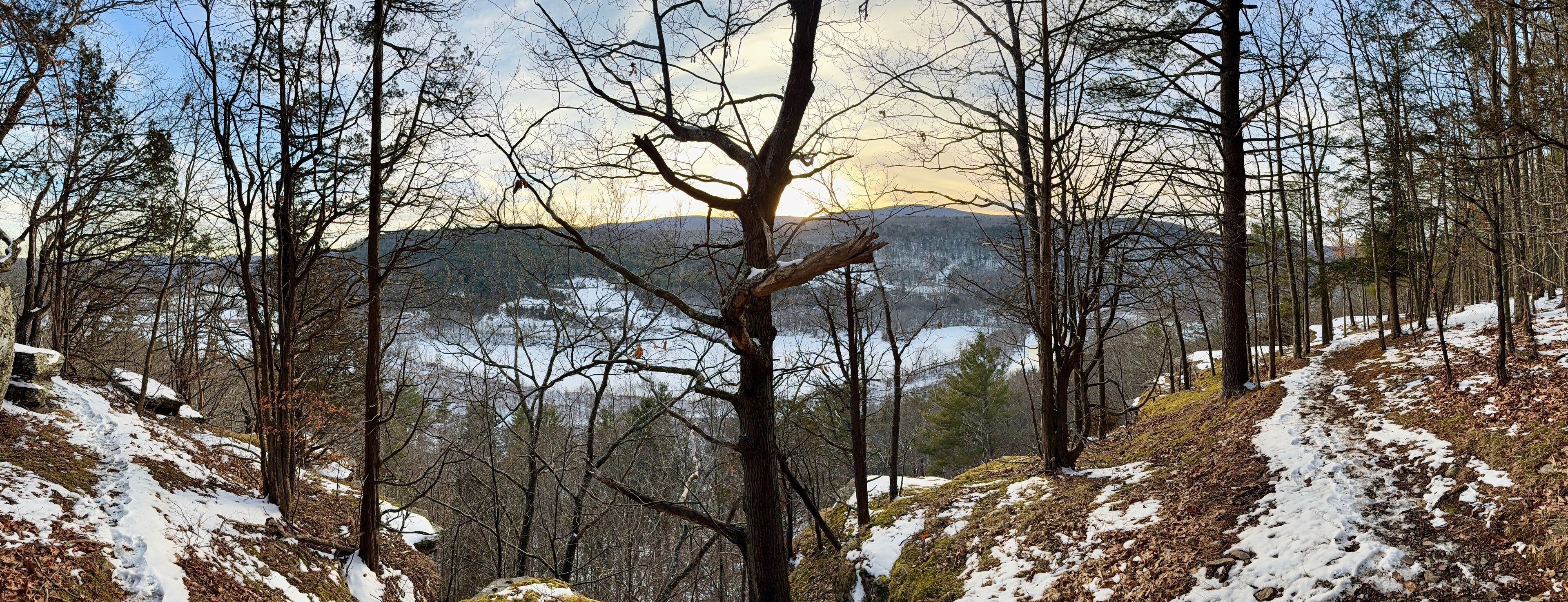 Prattsville, NY, USA - Dec 27, 2024. Uphill, short mountain hike to Pratt Rock. Mount Rushmore of upstate New York. Cliff stone carving for Zadock Pratt. Nearby dog and horse tombstone, valley view.