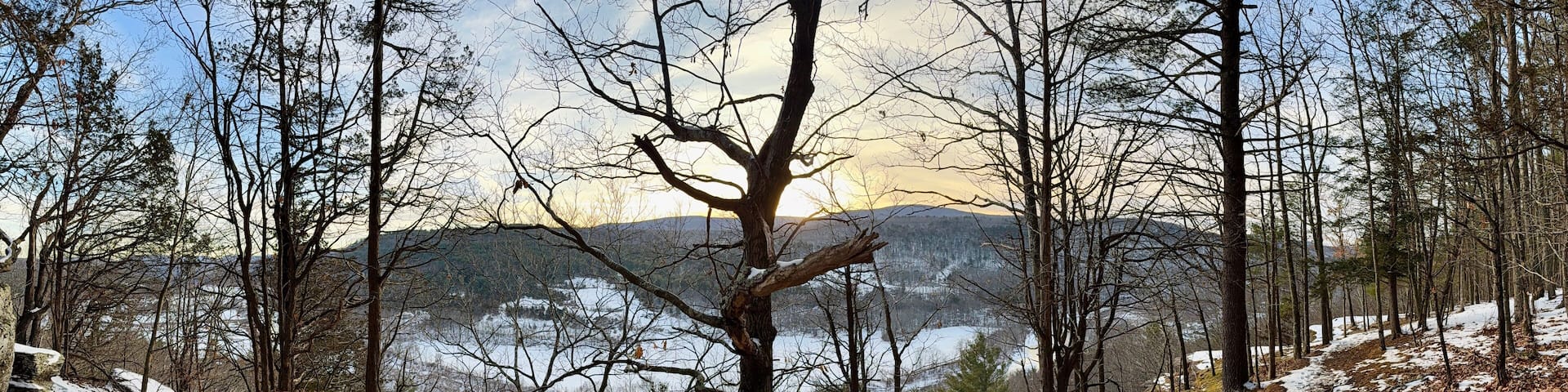 Prattsville, NY, USA - Dec 27, 2024. Uphill, short mountain hike to Pratt Rock. Mount Rushmore of upstate New York. Cliff stone carving for Zadock Pratt. Nearby dog and horse tombstone, valley view.