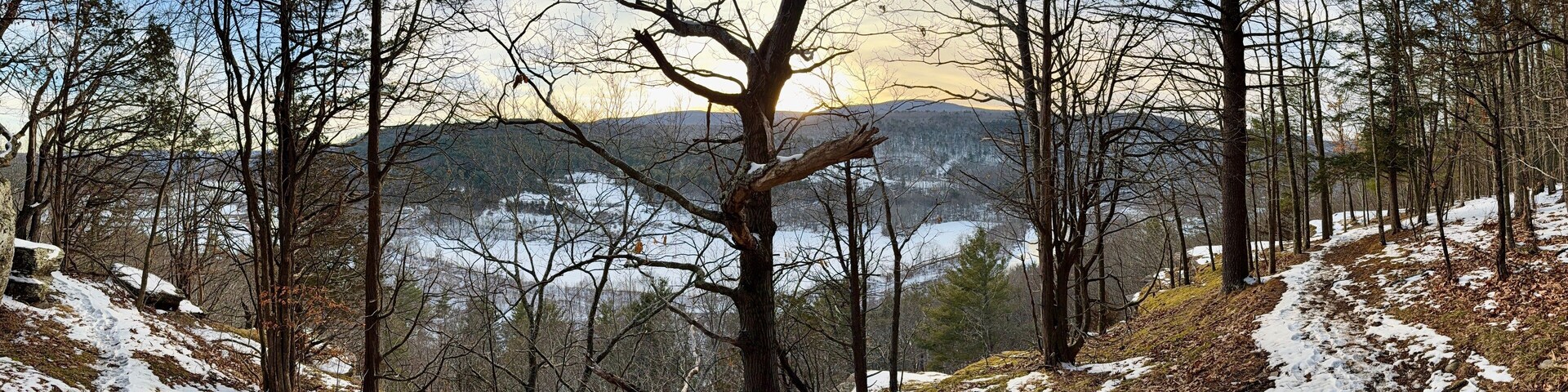 Prattsville, NY, USA - Dec 27, 2024. Uphill, short mountain hike to Pratt Rock. Mount Rushmore of upstate New York. Cliff stone carving for Zadock Pratt. Nearby dog and horse tombstone, valley view.