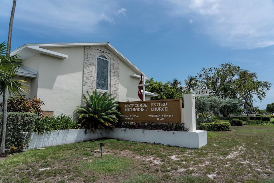 A church sign with the name Matecumbe United Methodist Church, listing Sunday School and Worship Service times.