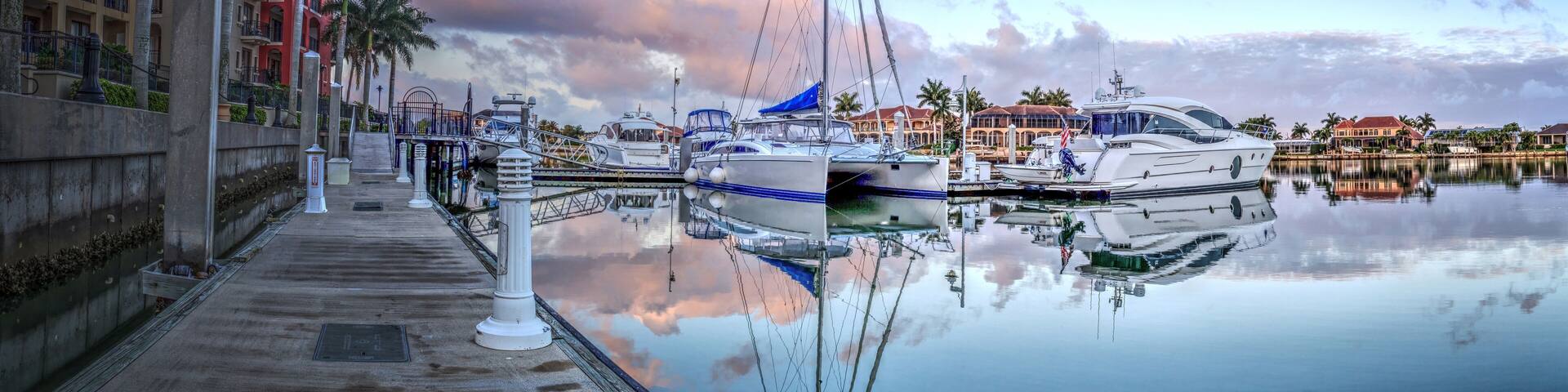 Sunrise over the boats in Esplanade Harbor Marina in Marco Island