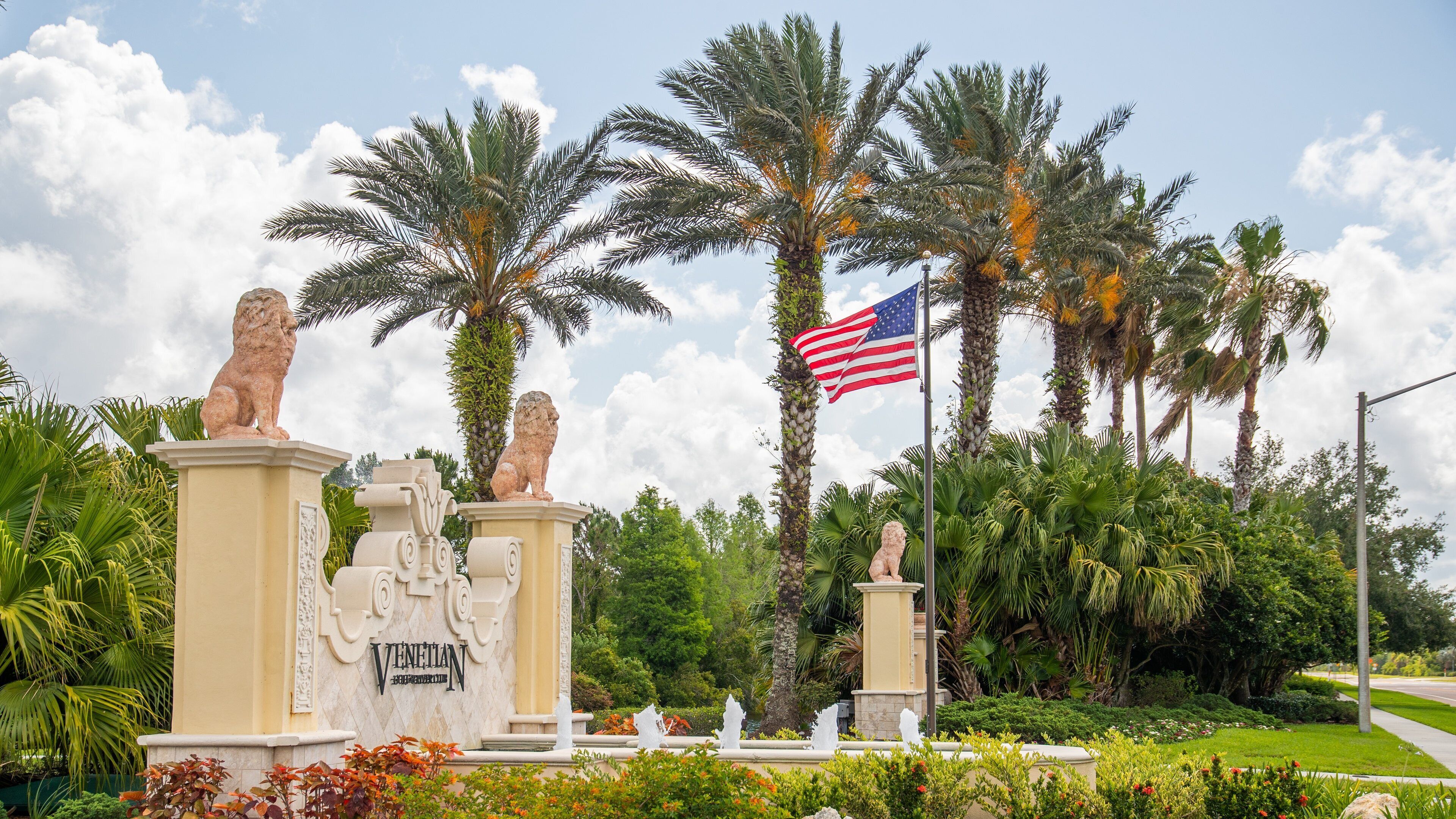 Venetian Golf and River Club showing signage and a park