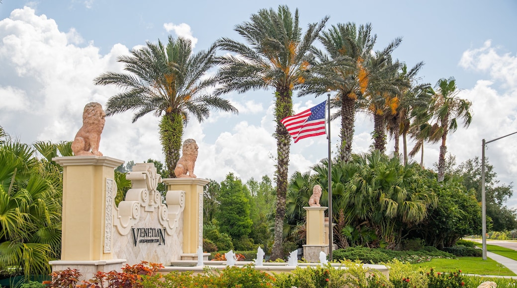 Venetian Golf and River Club showing signage and a park