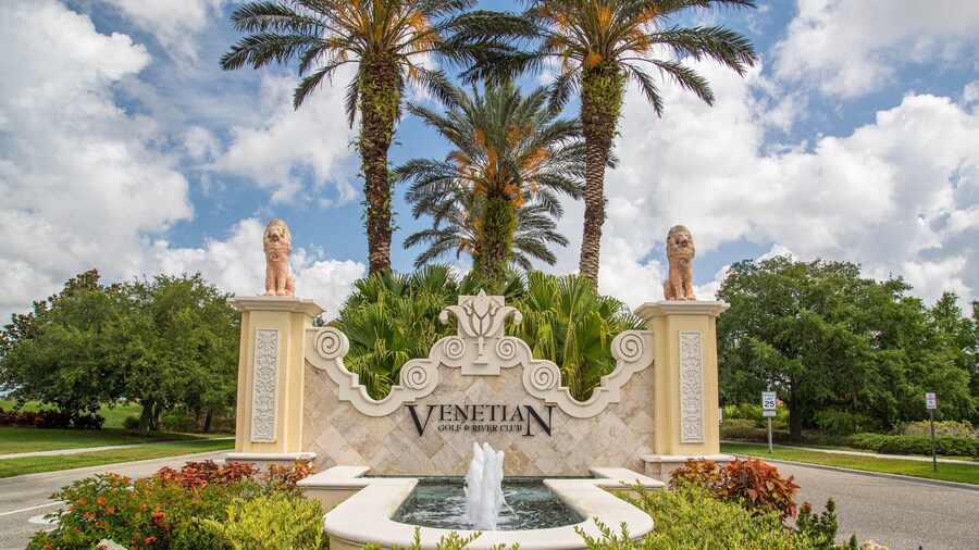 Venetian Golf and River Club which includes signage and a fountain