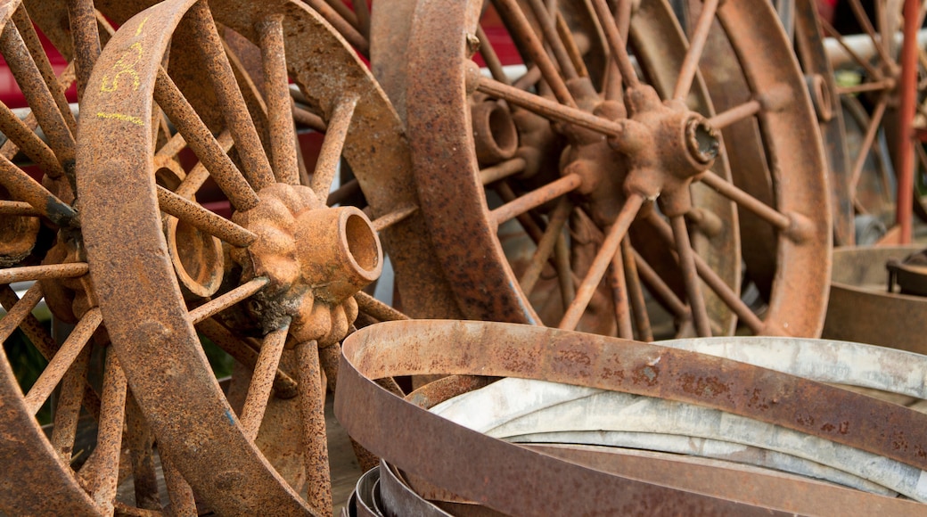Large pile of rusted wagon wheels
