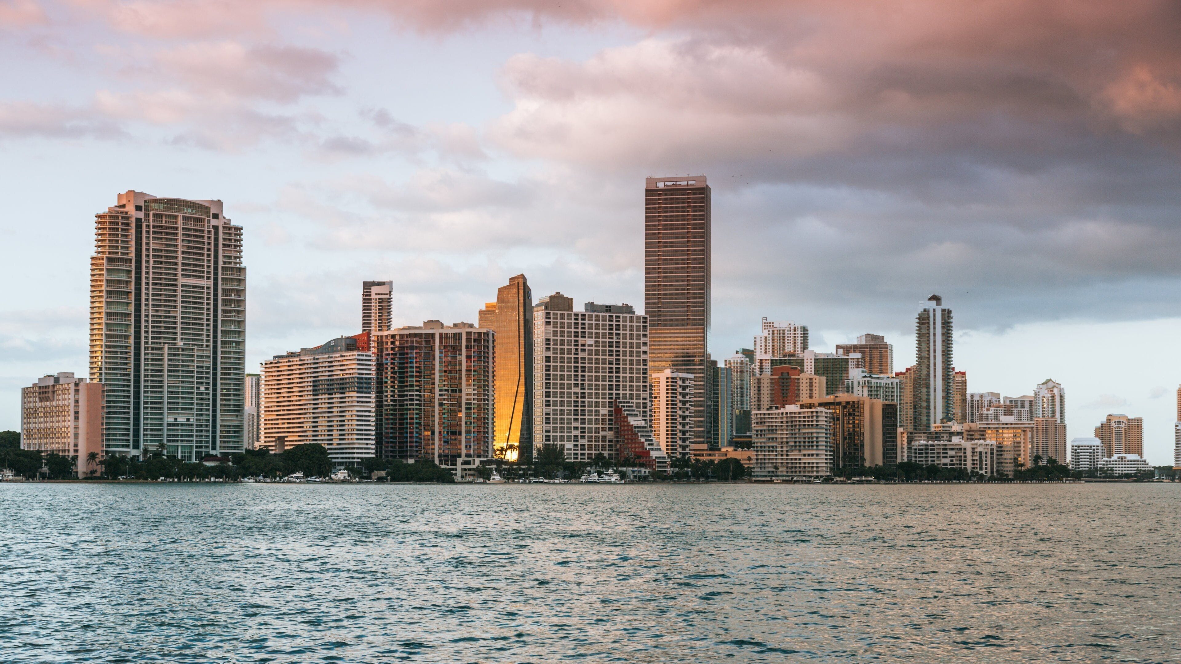 Rickenbacker Causeway Beach showing a sunset, a bay or harbor and a city
