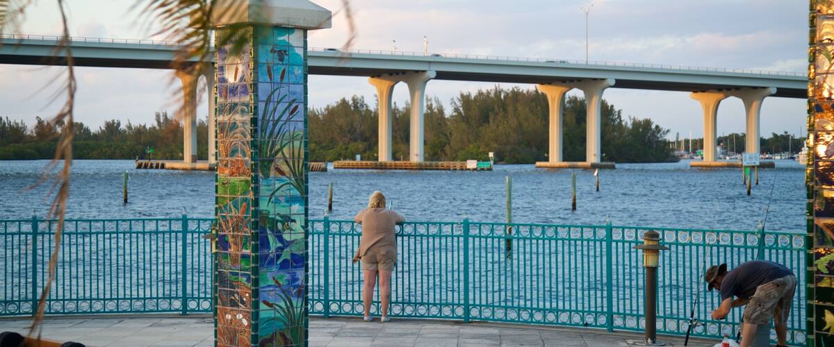 Royal Palm Pointe Park featuring outdoor art, a bridge and a river or creek