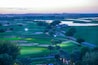 Aerial view of a golf course at sun set