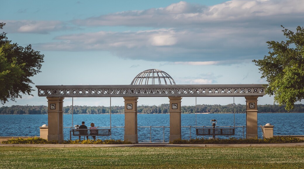A couple sits on a swinging bench by Lake Monroe in downtown Sanford, Florida.