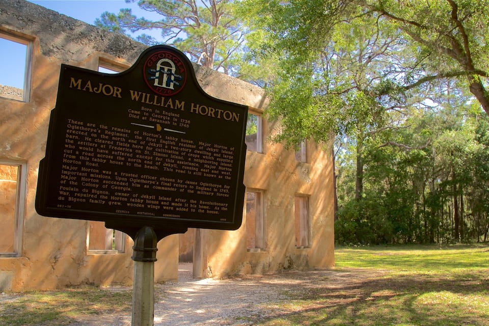 A historical marker for Major William Horton in a wooded area with a building in the background.