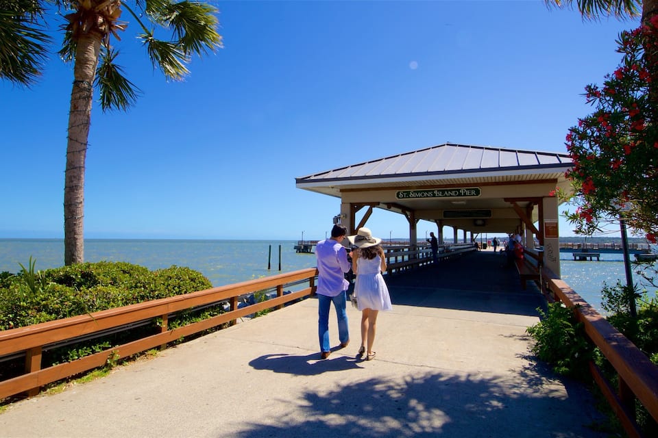 A pier with a sign reading "Simons Island Pier" leading to the water.