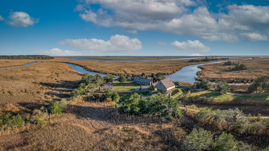 Aerial view of Fort King George historic site, oldest English fort on the Georgia coast from the 17th century with wooden palisade, gun ports for cannons blue cloudy sky near Darien Georgia USA