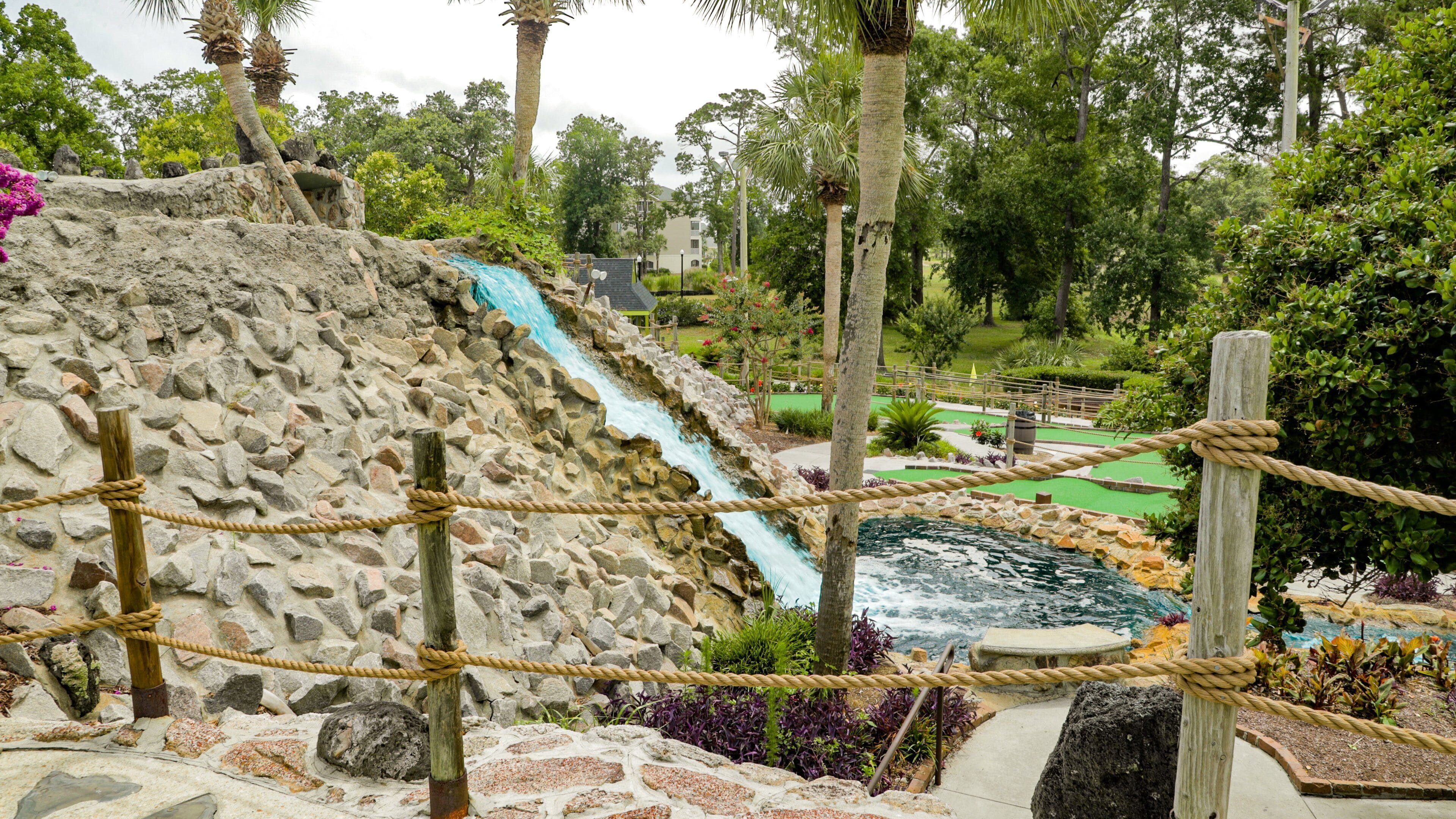 Jurassic Golf featuring a fountain and golf