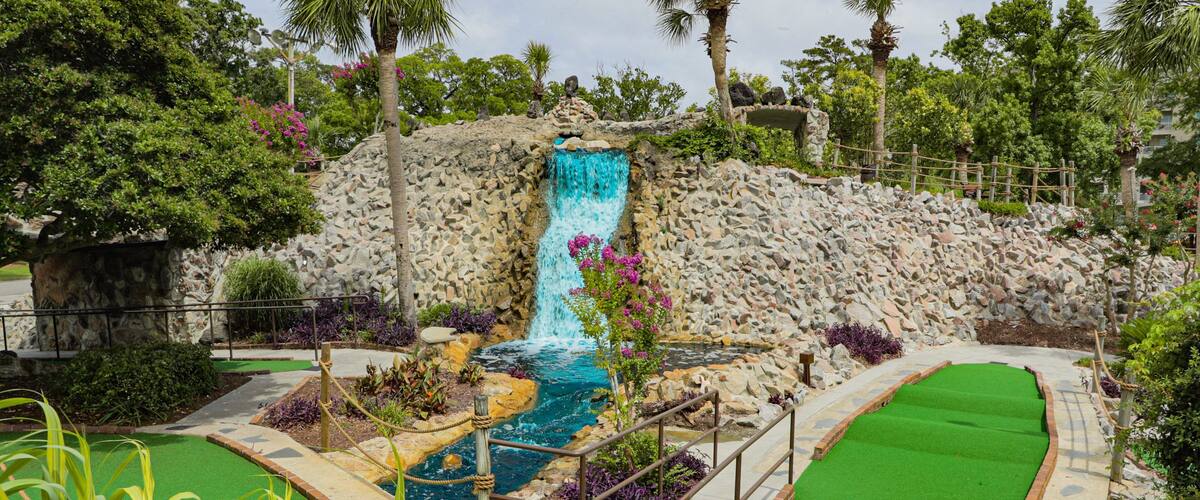 Jurassic Golf which includes a fountain and golf
