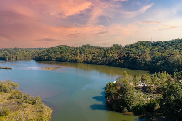 Aerial view of water at Morgan Falls Overlook Park with pink and blue skies