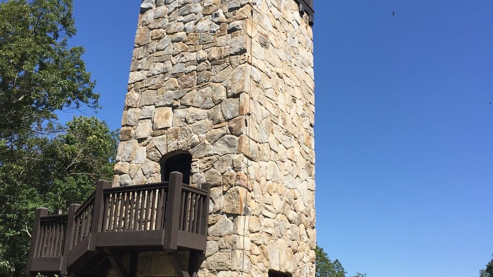 A stone tower with a wooden balcony.