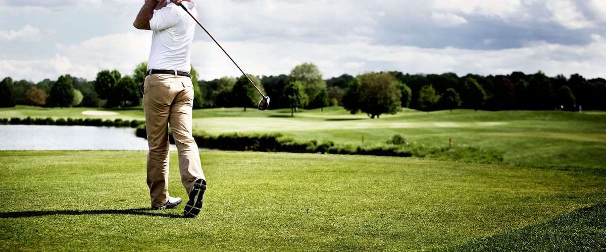 Golf player teeing off